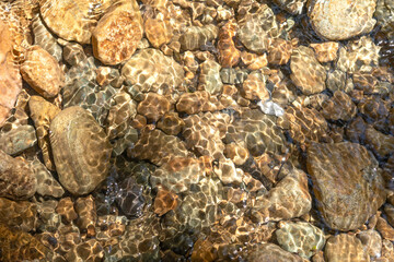 Clear water in the river and stone texture