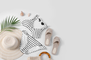 Flat lay composition with beach accessories on white background. Space for text
