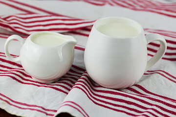 two white milk jugs