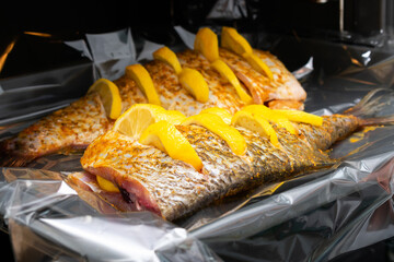Bream fish in the oven. Open built-in convection oven in the kitchen