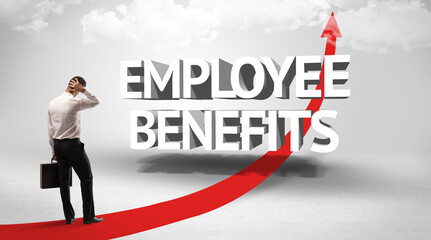 Rear view of a businessman standing in front of EMPLOYEE BENEFITS inscription, successful business concept
