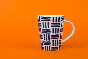 Blue abstract design cup isolated on orange background