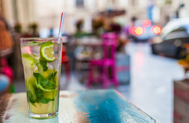 Non-alcoholic or alcoholic mojito on table at summer cafe