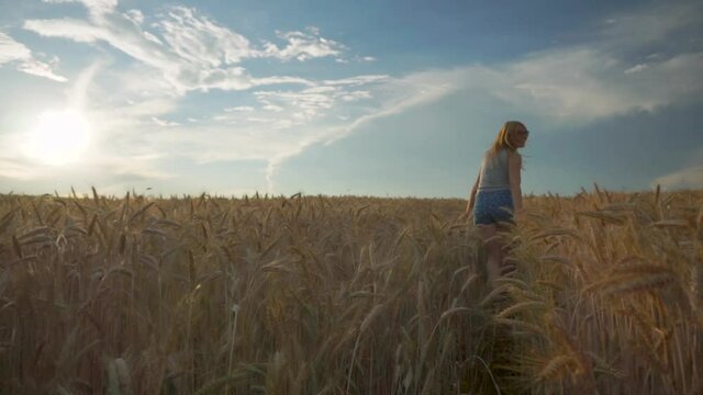 Happy-Go-Lucky Woman Running Through a Field of Golden Wheat