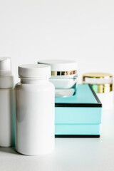 White plastic cosmetic bottles and turquoise and black gift box.