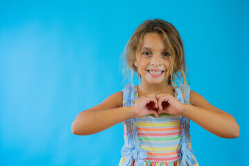 Little girl with swimsuit making heart figure