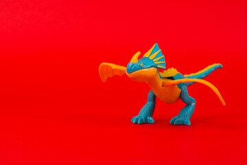 Dragon plastic kids toy isolated on a red background