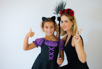 Family fun mother and child daughter having fun and celebrate Halloween in witch costume