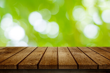 Naklejka na ściany i meble Empty wooden deck table with garden bokeh background. for product display montage.