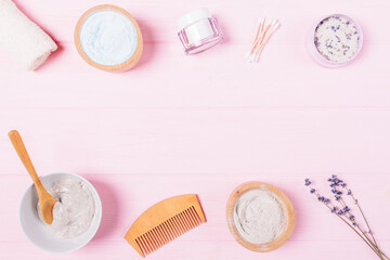 Fototapeta na wymiar Clay face mask and natural cosmetics on pink table