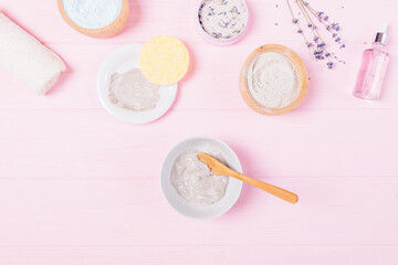 Bowl homemade clay face mask next to cosmetic ingredients