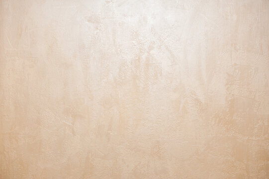 Wall decor Venetian decorative plaster with golden glitter paint. Background, abstraction. Apartment renovation concept. copy space