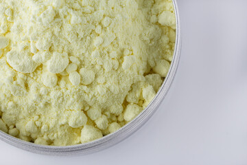 purified sulfur powder on a white acrylic background