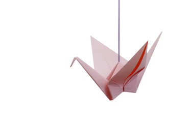 Fototapeta premium A pink paper crane on wooden