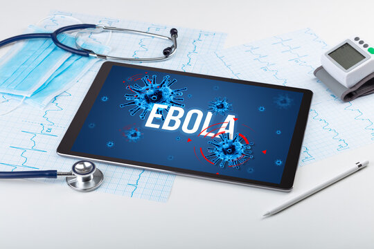 Tablet pc and doctor tools on white surface with EBOLA inscription, pandemic concept