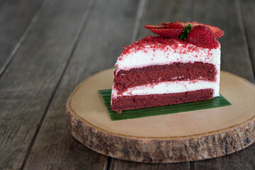 Red Velvet Cake with Fresh Strawberries Put on a round wooden tray instead of a plate.
