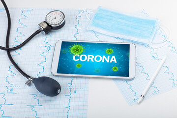 Close-up view of a tablet pc with CORONA inscription, microbiology concept