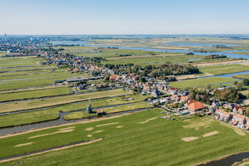 Aerial view of over Historic dutch Waterland landscape, With An Old Fashioned Architectural Dutch Town