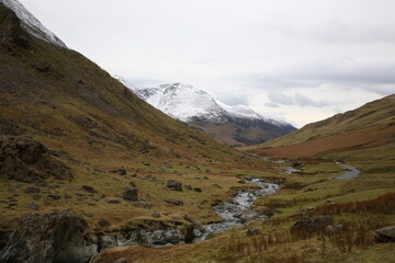 Scenic view of Newlands Valley with snow mountains and grassland during early Spring at  Keswick, Lake District National Park, Cumbria, England UK