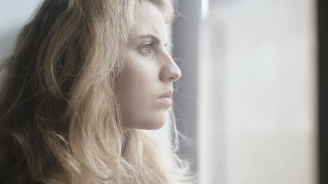 young thoughtful woman looking down thinking about her ex boyfriend