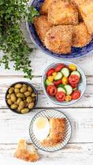 Plate with Burek, eggs, salad and Olives. Mediterranean style breakfast