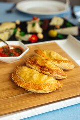 Spanish empanadas with sauce on restaurant table