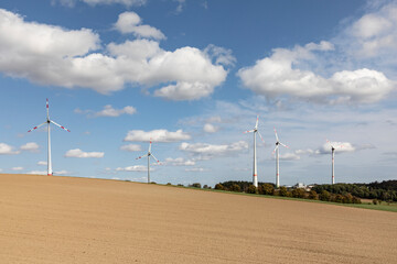 wind farm in the taunus region under blue soft cloudy sky