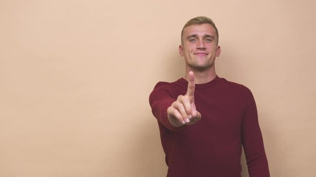 Young caucasian man showing number one with finger
