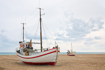 Fishing boats towed onto the beach of Slettestrand, North Jutland, Denmark
