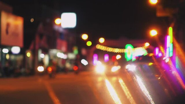 Blurred background of road traffic on night street in town. Bokeh lights