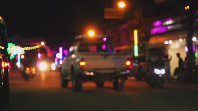 Blurred background of road traffic on night street in town. Bokeh lights
