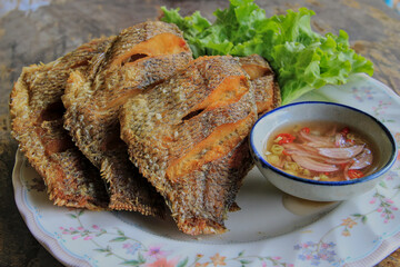 Deep-fried tilapia served with fish sauce, chili and onion mixed with lemon juice