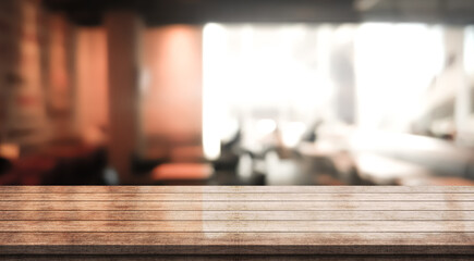 Empty wooden table top with lights bokeh on blur restaurant background