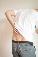 The guy is holding his back because of pain