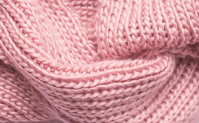 Texture of pink knitted scarf close up