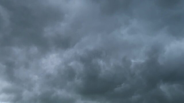 Atmospheric moody smoke clouds & dark scary gray cloudscape on rainy stormy sky horizon in tropical summer monsoon season before heavy thunder rain storm or dramatic hurricane, B-roll TimeLapse   