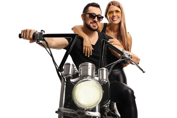 Obraz na płótnie Canvas Close up shot of a man on a chopper bike and a young woman behind