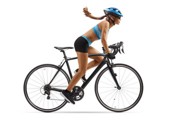 Fototapeta premium Full length profile shot of a woman in sportswear riding a bicycle with a helmet