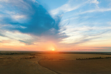 Naklejka na ściany i meble Amazing cloudy sky over fields, aerial view. Sunset landscape