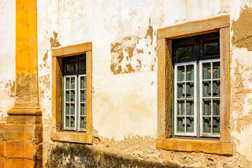 Historic church windows in colonial style with rustic stone frame in the ancient city of Ouro Preto in Minas Gerais, Brazil