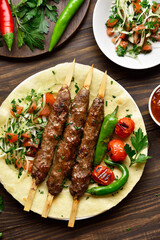 Turkish Adana Kebab with fresh vegetables on flatbread