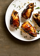 Roasted quails on plate