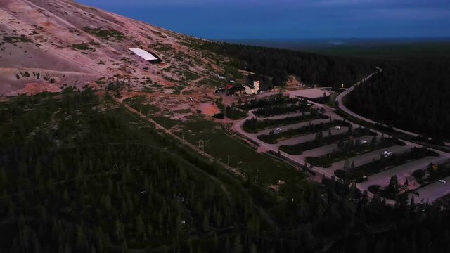 Aerial view of the Yllas fell and ski shop, on a colorful, summer dusk, during midnight sun, in Pallas-Yllastunturi national park, Kolari, Lapland, Finland - descending, dolly, drone shot