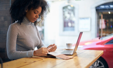 Focused young woman working remotely