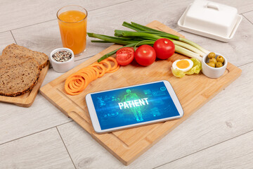 PATIENT concept in tablet with fruits, top view