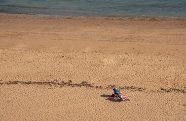 Fototapeta na wymiar People on the beach on the Kent coast.UK
