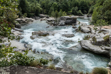 The Potholes of the Giants in the Toce River with green water and waterfall in Uriezzo