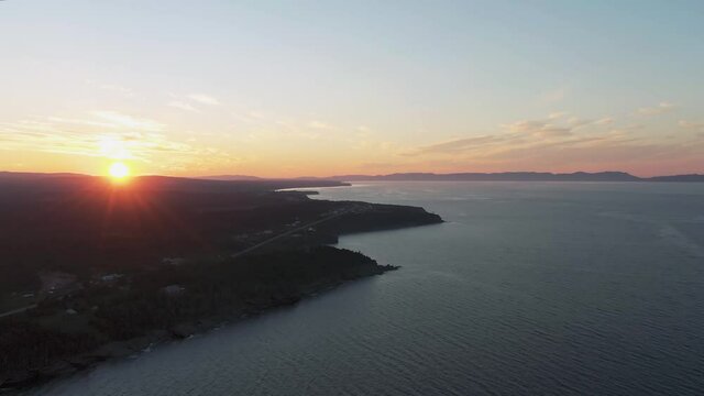 Stunning Golden Rays Sunset Beaming Across The Coast Of Gulf Of St. Lawrence In Canada - Aerial Shot 