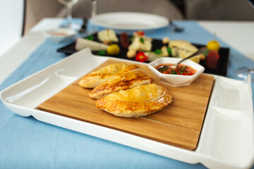 Spanish empanadas with sauce on restaurant table