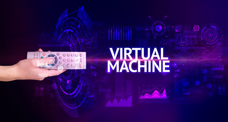 hand holding wireless peripheral with VIRTUAL MACHINE inscription, modern technology concept